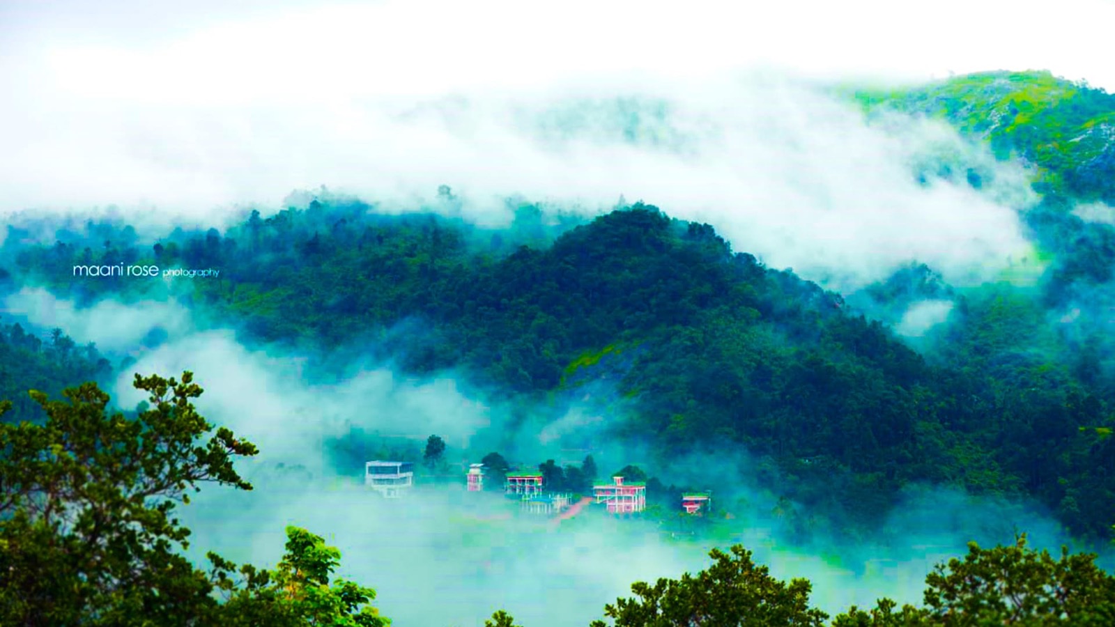 Sylvan Hills buildings, swimming pool and misty hills in Kakkadampoyil