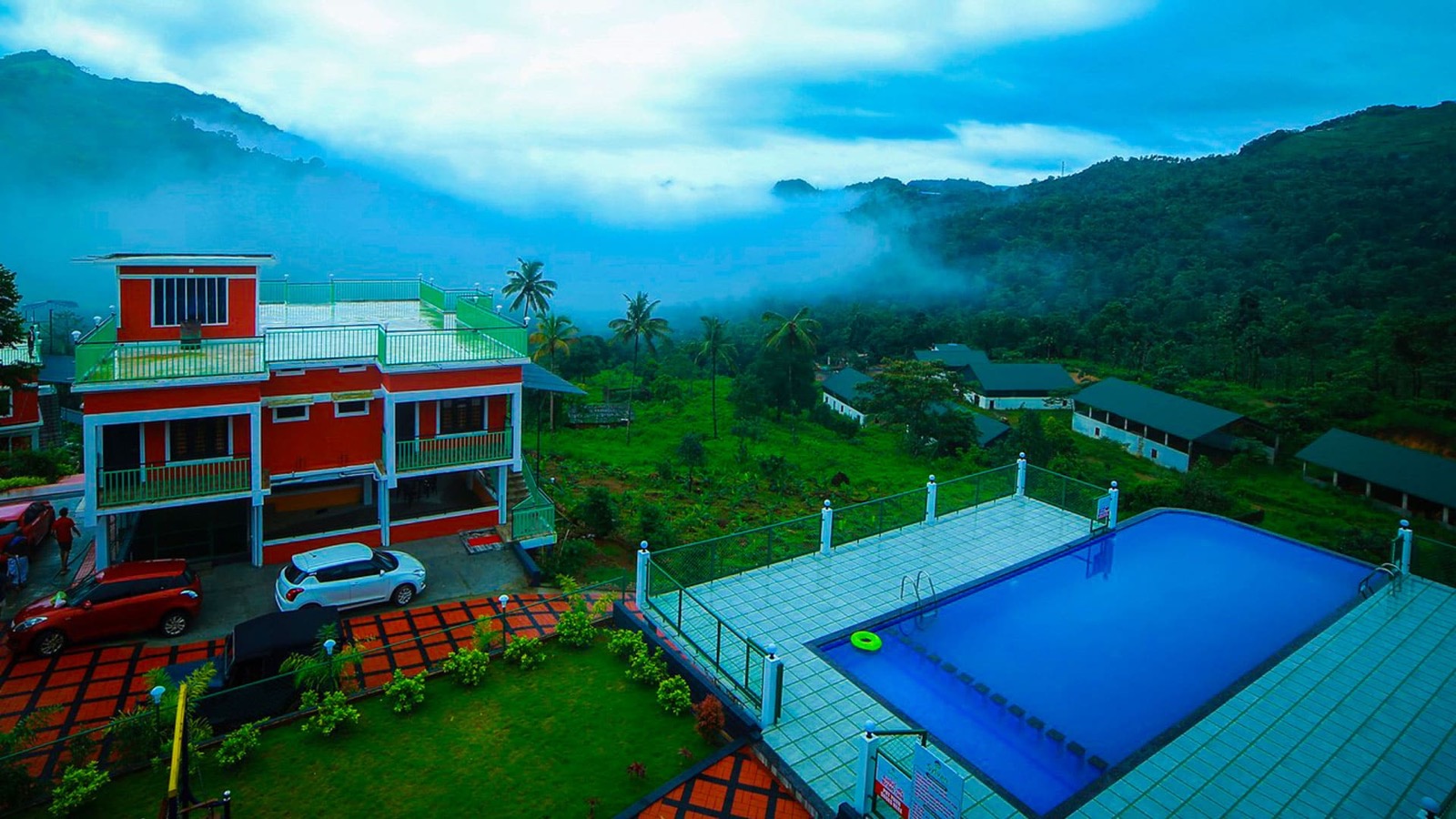 Actual view of the Sylvan Hills pool and green Kakkadampoyil hills